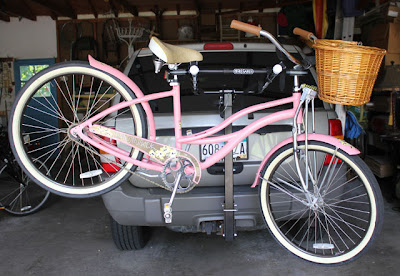 vintage style pink bike on a rear bike rack