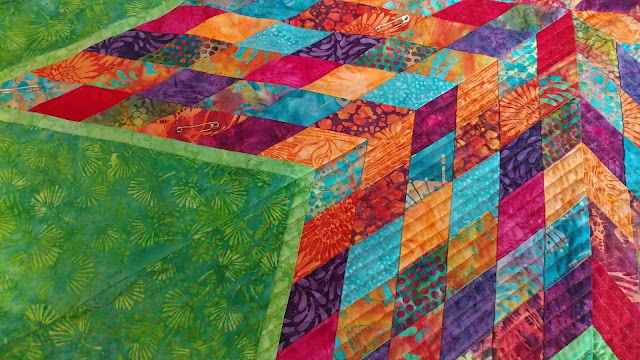 Scrappy Lonestar quilt using Empress Garden fabrics by Island Batik