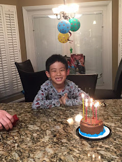 Grandson celebrating his birthday, boy and birthday cake