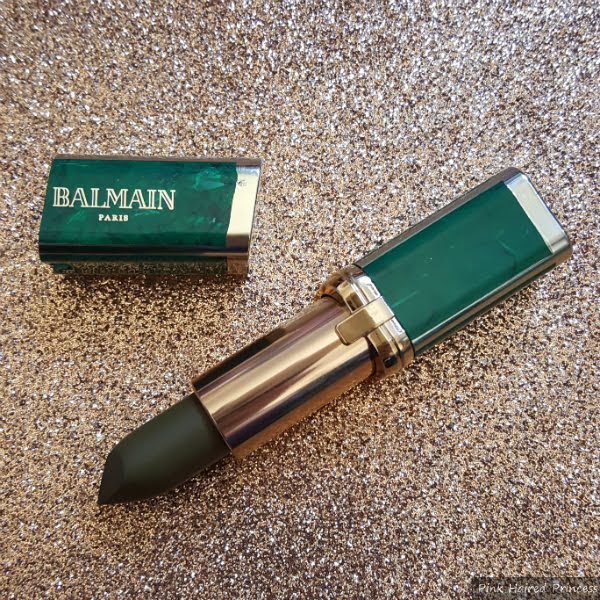 Balmain Instinct Lipstick loreal balmain green marbled lipstick with khaki coloured lipstick on glitter background