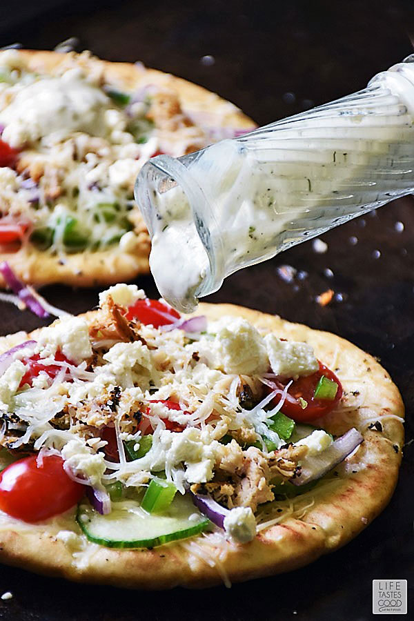 Drizzling Tzatziki Sauce onto Greek Pita Pizza
