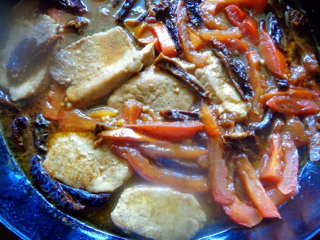 pork medallions cooking with tomatoes, stock and vinegar