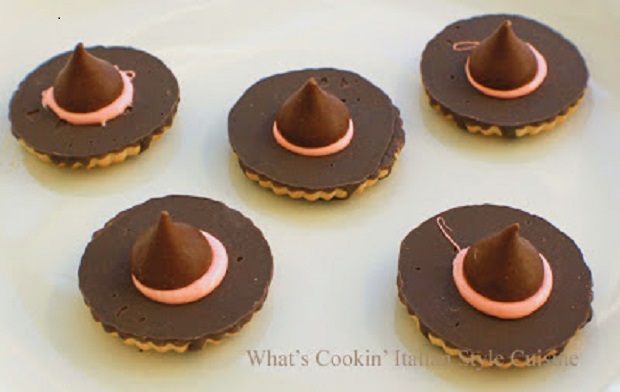 These are homemade cookies with a hershey kiss in the middle and frosting to glue it on to make a witch hat at Halloween