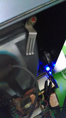 Vectrex internals with AudioPuck fitted with glowing blue light.