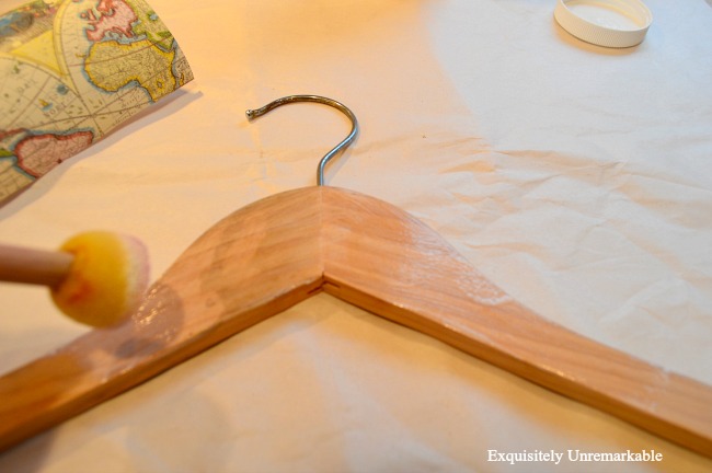 Add decoupage gel and wrapping paper to an old wooden hanger