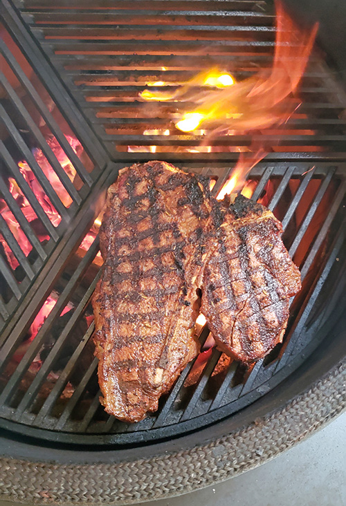 How to grill a thick porterhouse steak on a Big Green Egg kamado grill.  The grate is a Craycort grate. #BestAngusBeef #Steakholder