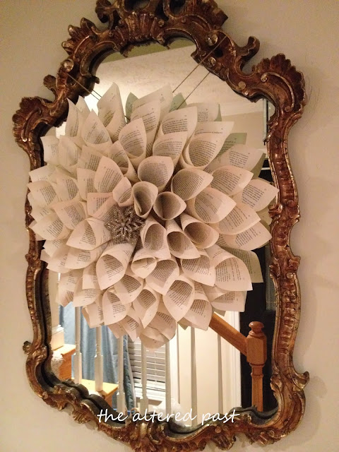 easy diy book page wreath hung on antique mirror