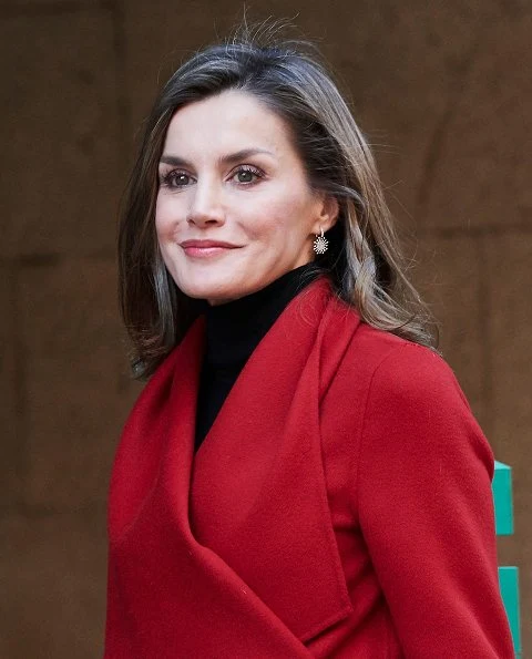 Queen Letizia wore Carolina Herrera red coat, Zara print skirt, and Zara Crossbody bag and Uterque red boots