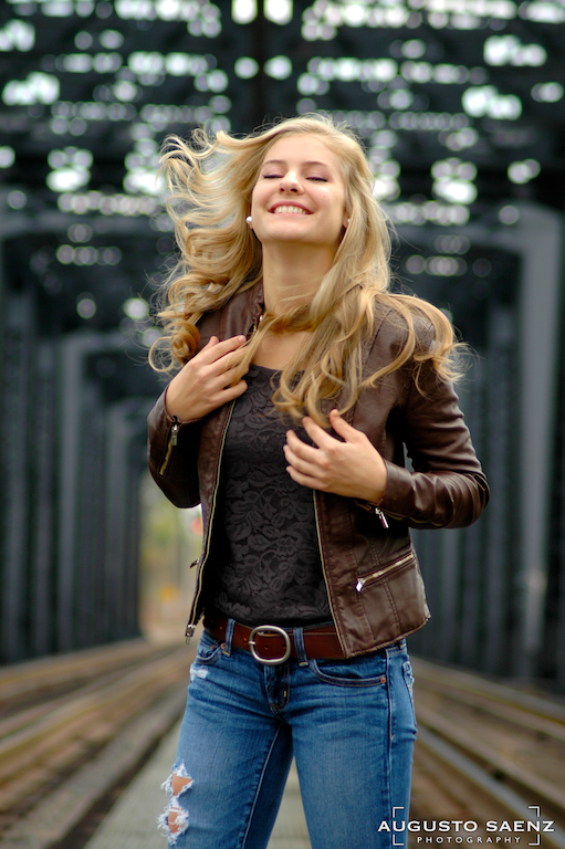 Blond Senior Girl by rail tracks with flying hair 