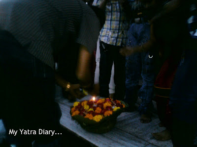A devotee lights a leaf diya to set afloat on the River Ganga at the Har Ki Pauri Ghat in Haridwar