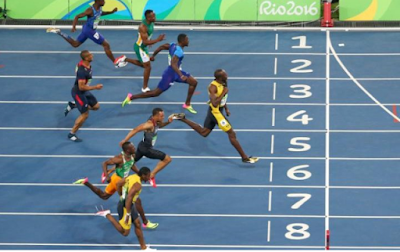 Usain Bolt starts celebrating as he crosses the finish line