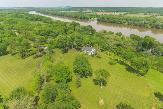    This is an extraordinary opportunity to own one of the Stately Waterfront Estate on 49+ Acre parcel overlooking the Potomac River in Leesburg. Filled with Serenity and grace, entertaining in this 1920's mansion will be a joy. From the spacious kitchen, to the banquet sized dining rooms to outdoor patio, multiple decks and grounds this elegant home was built to make your guests feel special. Also on the property are the contributing Gardener's Cottage, the Barn, the Pumphouse, the Garage & 2 Boat Ramps. Just Listed For Sale LO9658738, 42476 WHITES FERRY RD, LEESBURG, VA 20176 Just Listed For Sale LO9658738, 42476 WHITES FERRY RD, LEESBURG, VA 20176      Just Listed For Sale LO9658738, 42476 WHITES FERRY RD, LEESBURG, VA 20176 Just Listed For Sale LO9658738, 42476 WHITES FERRY RD, LEESBURG, VA 20176 This is an extraordinary opportunity to own one of the Stately Waterfront Estate on 49+ Acre parcel overlooking the Potomac River in Leesburg. Filled with Serenity and grace, entertaining in this 1920's mansion will be a joy. From the spacious kitchen, to the banquet sized dining rooms to outdoor patio, multiple decks and grounds this elegant home was built to make your guests feel special. Also on the property are the contributing Gardener's Cottage, the Barn, the Pumphouse, the Garage & 2 Boat Ramps.                                                                                                                                       About Loudoun About Loudoun  Largely rural Loudoun County is a picturesque region in the metropolitan area of our nation's capital. It is home to 12 wineries, 25 active farms and a thriving equine industry. Recently, the county's population has grown at a rapid pace paving the way for a service economy and pockets of industry surrounding Washington Dulles International Airport. With this expansion has come a rapid increase in luxury homes that dot the scenic countryside. Development has occurred so quickly that the county has toughened regulations and placed restrictions on building, which has helped retain a bucolic feel and has made owning a Loudoun luxury home all the more exclusive.  Amber Creek Estate & Vineyard near historic Leesburg Virginia is elegantly situated on 23 exceptional acres with over 8000 custom finished square feet. The additional Carriage House has a full apartment and really a second home on the property. Designed in conjunction with the breathtaking views and the scenic vista, this one-of-a-kind Schulz home was hand-crafted in stone & stucco in the French-country style and is accented by its 5-acre vineyard producing award-winning Chambourcin grapes.  To finish this Thomas Kincade artwork, visualize an outdoor oasis with an in-ground pool and spa, a built-in grill amidst an extensive flagstone patio and entertainment area with beautiful landscaping and perennials abound . . . also, there is a cabana (private gazebo) for shade and to unwind.  Aesthetically, the home is a haven in its own right . . . but the property also has its own wild Trout stream running through it that the VA Department of Game and Inland Fisheries has deemed “The only (natural, spring-fed) wild Trout stream in northern Virginia.”   The private Big Spring Farm community is adjacent to the historic Whites Ferry and the Potomac River. Designed as an equestrian community, its homeowners benefit from the beautiful walking paths and natural springs/streams (private wells flow at an average of 100-200 gallons per minute) that run through this property (and through only a few estate homes) as well as through the HOA-owned picturesque historic barn and gazebo area used for picnicking and community events. The Trout stream, which runs within some of the common area is owned by one of two homeowner’s associations as it meanders along the walking trails and feeds to the Potomac River. Recently the VA Department of Game and Inland Fisheries has visited Big Spring Farm and stated their upkeep/preservation will protect the stream for decades to come. Please inquire as there is much more information available about the wild Trout stream. The stream enhances any agricultural piece of land available in the County available today.   When speaking of the vineyard, it is important to note it was designed by wine experts and is one of the reasons the owner feels it has been such a success.  Whether you want to own and enjoy the vineyard at an arm’s length or be fully hands-on in its day-to-day operation, one can relish in this gem while catering to one of Loudoun County’s fast-growing attractions. Already paired with several local wineries, agreements are in place if the buyer would like to have local wineries harvest the grapes or do their own thing. The vineyard is surrounded by an irrigation system and electrical fence to preserve the precious vines, and vineyard equipment also conveys.  A note worth mentioning . . . horses would be ideal on the property as well and reside in the community already. The 23 acres can accommodate a barn and/or paddocks (see photos) while still allowing the 5 acres of grape vines to remain intact. Expanding the vineyard, also an option.  The home offers 6 bedrooms (1 in the Carriage House and 1 being used as a second upper-level media room could make 7) and 7 ½ baths, including the Carriage House full bath. Crown moldings, built-ins, granite organizational stations and quality construction detail are some of the many exceptional finishing touches that makes this estate so well appointed . . . too much detail to put in print.  On the warm and inviting main level is the exceptional Owner’s Suite and Luxurious Bath, a Gourmet Kitchen with the finest appliances, a breakfast and “keeping room” with fireplace off the kitchen, an inviting two story open family room with fireplace and numerous, quality custom built-ins - from all of these rooms, the view is 360 and spectacular surrounding the property. Also on the main level is a library with built-ins, a professional office/art studio and much more.  Upstairs you will find 3 additional bedrooms (a 4th potential, now a media room) and 3 full baths. All bedrooms boast custom designer window treatments, hardwood flooring and they each have their own bath.  On the lower level you will enjoy a media room, an exercise room/gym (equipment conveys), the perfectly-situated full bathroom (1 of 2) with a private sauna to relax in after a workout - or your guests are able to stay in the lower level bedroom with full-size windows and walk-out also having its own bathroom.  Also in the lower level, and deserving of its own passage, the owner left “no stone unturned” inviting you to enter an exceptional hand-crafted and curved (stone) wine tasting cellar. One will rarely find a tasting area or wine cellar in their world travels like this – the cellar doors are custom and just exquisite. For the occasional cigar smoker, the “cave” has a high-tech ventilation system as well.  View next one of probably the most aesthetically-pleasing Carriage Houses, designed to accent the estate (and topography) in an old-world Tuscan-style exterior. The Carriage House includes a turn-key apartment perfect with its separate entrance for your guests, family or a future stable hand or even a vineyard caretaker.  Below is a 4-car garage.  The views of the grounds of the property are one of the many joys in owning this marvelous estate, and they are not to be missed from the steps of this particular Carriage House.  Stroll along the stream and along private walking paths or enjoy the heavenly custom pool and spa area with a lovely gazebo for shade and/or enjoyment of acres and acres of beautiful land tumbling with flowers and perennials, all professionally landscaped.  Tucked away in this very private community with no through streets, Big Spring Farm is only a couple of miles to downtown, historic Leesburg, near the Toll Road and only 20 miles to Dulles Airport.  Enjoy the breathtaking countryside or hop into downtown Leesburg for its social life and enjoy First Fridays, shopping, fine or casual dining and summer concerts.  Area events, Morven Park nearby and so much more, make this location sought-after and very unique.  A commuter’s dream, the estate is near the historic Whites Ferry, downtown Leesburg, Raspberry Falls Golf Course and a few miles to the Villages at Leesburg and the Wegmans Shopping District.  For the historical buffs, the owner has compiled records that date the area back to the 17the Century, located along the Potomac and many artifacts have been found by homeowners from previous wars as troops marched and crossed the Potomac to Ball’s Bluff Battlefield.  In line with the topography and its beautiful horse and vineyard properties within this equestrian community, residents also enjoy a private 2-mile walking/jogging path known only to Big Spring residents or their invited guests. Because horses are within the community, the paths are also open to riding and run along the Potomac River.  Please inquire. Your boats can easily be launched at the docking station on the informational side of the historic Whites Ferry as well.  The supreme location of this vineyard and all-around phenomenal estate and private acreage near downtown, historic Leesburg . . . and with schools within a mile of the subdivision, truly this property is a “rare opportunity" in Loudoun County and what dreams are made of  Exquisite 10,000 square foot estate on a scenic six acre lot in Grenata Preserve. Grand two-story foyer with sweeping staircase, two decorative see-through fireplaces plus third fireplace, custom moldings, arched openings to gathering rooms, gourmet kitchen with stainless steel GE Monogram appliances, light-filled two-story conservatory, custom lower level with granite wet bar, theater, two bedroom suites. Gorgeous landscaping. Own private entrance from Evergreen.  Property Features Include: 3 Fireplace(s), garage, circular driveway, ceiling fan(s), zoned central air conditioning, forced air heating system, null, fully finished walkout basement, sump pump               40903 Grenata Preserve Pl, Leesburg, VA, USA, 20175 Email an Inquiry 35170 Poor House Ln, Round Hill, VA, USA, 20141 Email an Inquiry 38188 Lime Kiln Rd, Middleburg, VA, USA, 20117 Email an Inquiry 439a Springvale Rd, Great Falls, VA, USA, 22066 Email an Inquiry 938 Peacock Station Rd, Mclean, VA, USA, 22102 Email an Inquiry 7020 Green Oak Dr, Mclean, VA, USA, 22101 612 Rivercrest Dr, Mclean, VA, USA, 22101  5335 Summit Dr, Fairfax, VA, USA, 22030 9020 Belcourt Castle Pl, Great Falls, VA, USA, 22066 300 River Bend Rd, Great Falls, VA, USA, 22066 