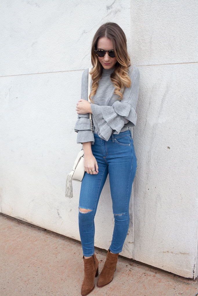 A ruffle sleeve sweater paired with distressed denim. 