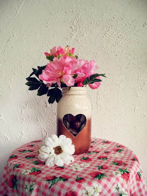 A DIY ombre jar with a heart and flowers and rocks