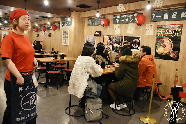 waitress and group of customers on a table in a Japanese restaurant