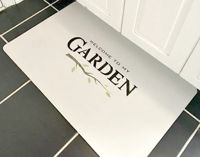 Mat with stenciled garden sign