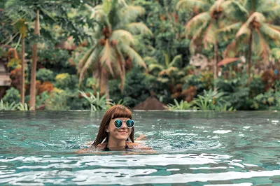 woman swimming in stunning tropical pool