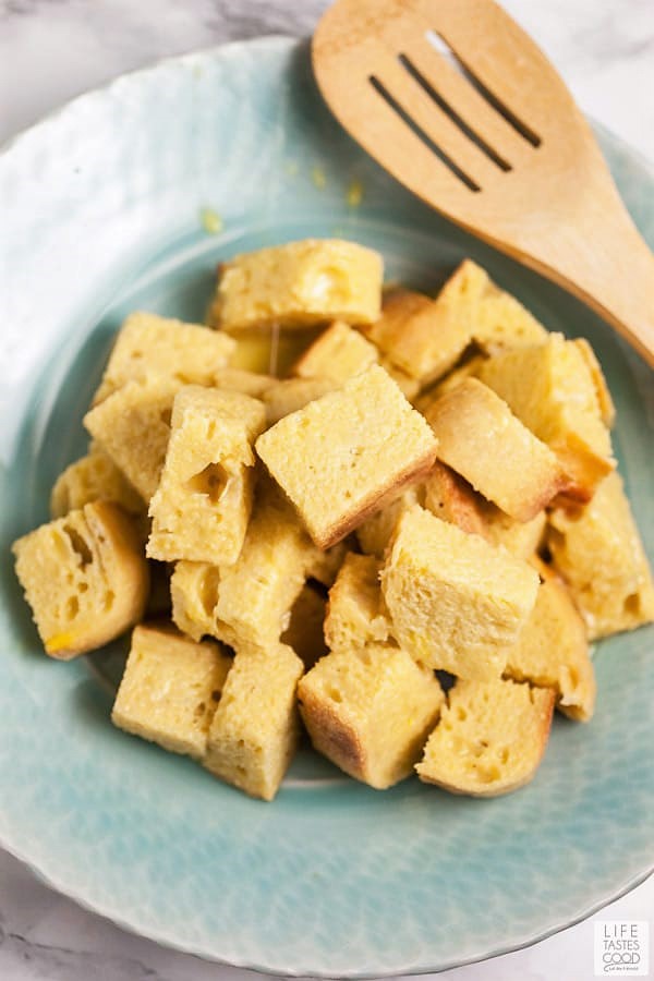 Soaked bread cubes transferred to a bowl before frying up in a skillet for cinnamon french toast bites