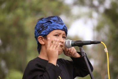 Seorang seniman anak mahir memainkan Karinding. Seorang seniman anak mahir memainkan Karinding.