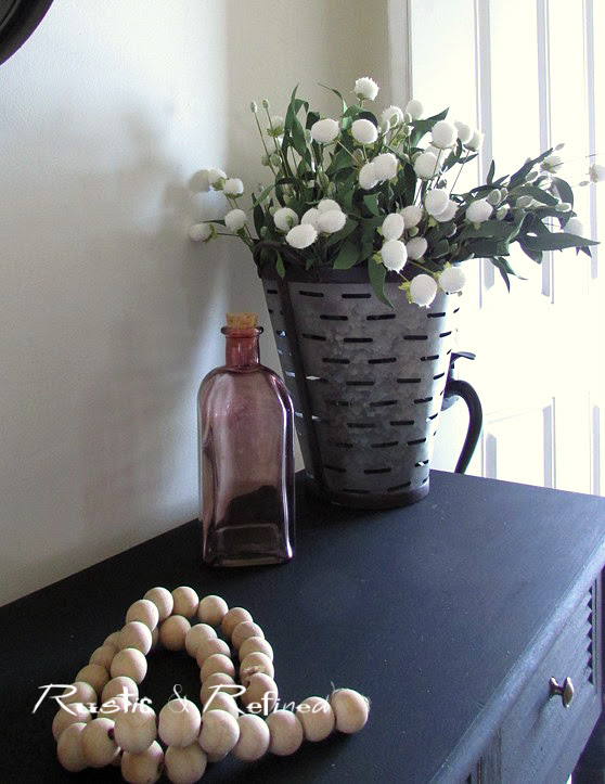 Front hall table in the entry decorated with farmhouse style