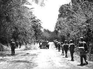 Image credit: United States National Archives. US troops moving into Santo Tomas, Batangas March 1945.