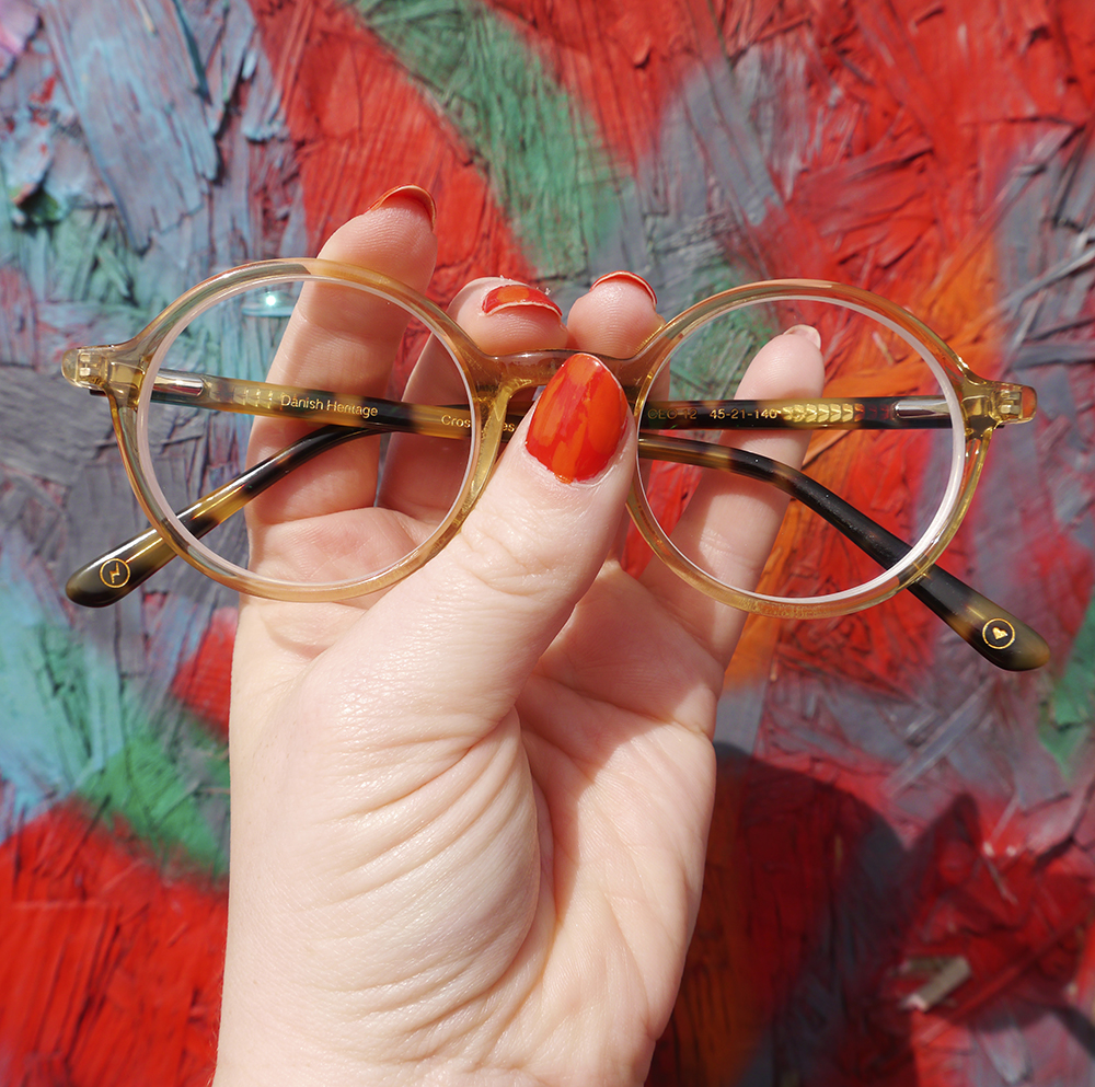 CrossEyes Edinburgh Circle Frame Glasses Hand with red nail polish holding CrossEyes Edinburgh Circle Frame Glasses