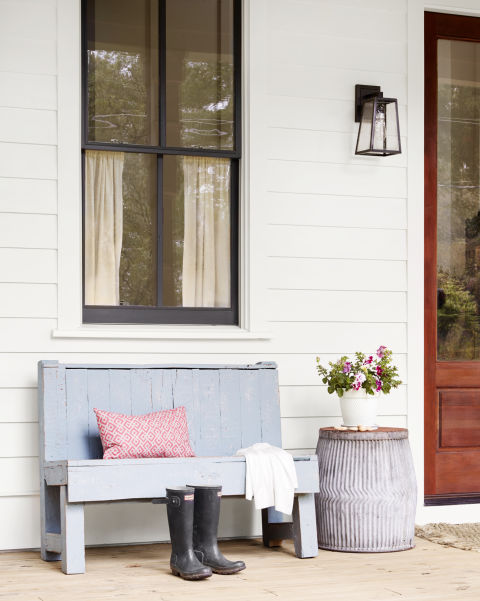 Charming blue bench on porch with white clapboard siding and beautiful modern farmhouse style inspiration on Hello Lovely Studio