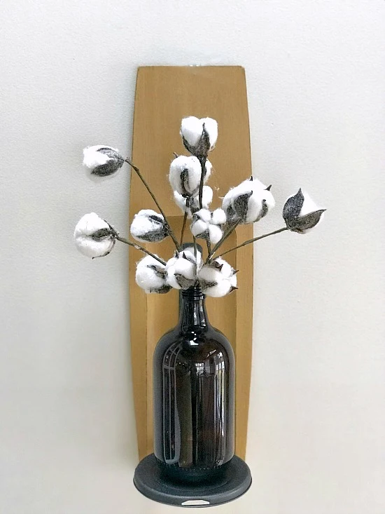 wall shelf with bottle of flowers