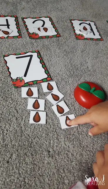 A cute way to tie in Ten Apples Up on Top with some gross motor and balance practice for toddlers!  Balancing apples plus a free appleseed counting activity is perfect for young kids to try in the fall.