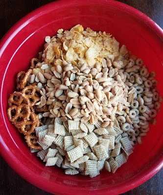 bowl of pretzels, cereals, peanuts etc ready to be made into snack mix