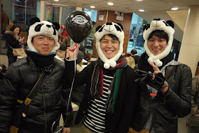 Japanese guys wearing panda hats and holding a Dickies balloon