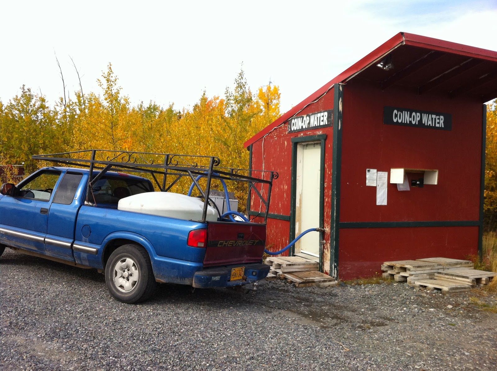 Getting water from a coin operated pump house in Gakona, Alaska Pump house and water storage unit in rural Alaska