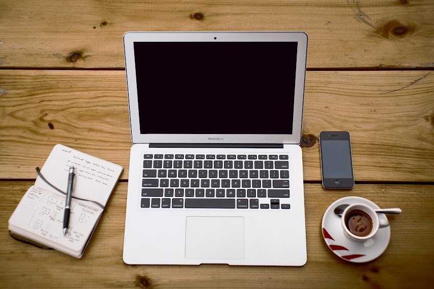 Laptop Book With Pen Phone And A Cup Of Coffee On Table Laptop Book With Pen Phone And A Cup Of Coffee On Table
