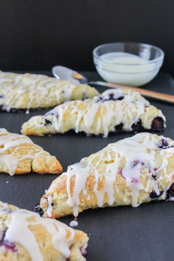 These Lemon Blueberry Scones are light and tender and packed with sweet juicy blueberries. The light drizzle of lemon glaze puts them over the top!