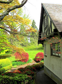 An arts-and-crafts-style cottage set in an english-style garden.