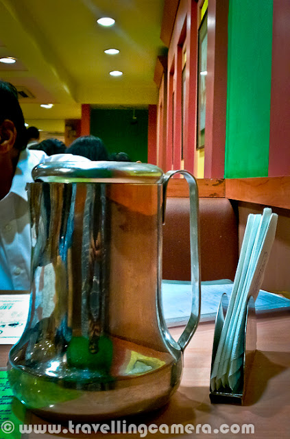 Few days back one of my friend told me about Sarvana Bhavan in Connaught place and we though of having lunch at the same place. It's just opposite to Janpath Market near CP, Delhi. Let's have a quick Photo Journey to Sarvana Bhavan in Connaught Place with some information about it's food and specialties...Welcome to Sarvana Bhavan. As you know, all popular places in Delhi are usually crowded. So the story of our lunch also started with waiting time for 25 minutes. And after a long wait we had to share the table. Since my friend was crazy about the South Indian food here, I simply followed the trends if Sarvana Bhavan. Otherwise I would have spent those 25 mins in locating some other good place which could offer comfortable seating at least.Here is what exactly we saw inside Sarvana Bhavan. Both of the floors were full of people and seating were extremely tight. There was hardly any space between the tables. It seemed that they get lot of customers daily and available real-estate need to be utilized in such a way.Place is fine for young and old age folks, but if someone want to visit the place with children, I would want to warn them. Waiting for 20 minutes at least and then getting into a tight space and get out of the space after finishing your food - This whole cycle will suffocate the kids with you. As there is no place for them to enjoy inside Sarvana Bhavan.Anyway, it was time to look at the menu and decide on items we wanted to have for Lunch. I got the reasoning behind the popularity and spacing problem. Their charges were very nominal. But I was expecting lovely south Indian food at same time. Let's see how it goes...We were sharing our table with this interesting couple, who ordered very unique items in lunch. They took enough time to look at all the items in Menu and then decided to have a special thali and Paper masala Dosa, with salted Dahi-Vada after main meal.Overall place was clean and comfortable, if we forget about the spacing. It's a completely air conditioned restaurant, which serve almost every South Indian Dish. Service was again good, as one person was dedicated for each row, who was only involved for taking order and making sure that no one is waiting for any type of service. Most of them communicate in South Indian Language(s)...We ordered on simple Thali and a Butter Rava Masala Dosa. I failed to notice anything good about the food here. South Indian at Sagar Ratna is far better that Sarvana Bhavan, but not sure why it's name is so popular. If you are reading this post and like Sarvana Bhavan food, please comment back and share about the things you like at this place.When we were waiting for our order to come, uncle and aunti were discussing about Sarvana Bhavan in Lajpat Nagar and they were really impressed by the food there. At the same time uncle received 4-5 calls and informed everyone that he is in CP Sarvana Bhavan with his wife.Here come our simple thali with a  two Masala Dosas, Sambhar, Coconut chutney, one Subzi & some rasam. And yes, Sweet halva was also part of this thali. Food was ok, but not something great or special... Give an option, I will never com back to this place and would love to go to Sagar ratna for real taste of South Indian Food.After having food expressions were really like this. Uncle was really disappointed with food and also gave the same feedback to manager on second floor. Although, Manager's expressions were saying that he was not bothered much about what the gentleman explained to him.Sarvana Bhavan is good for one time experience and then decide yourself :)