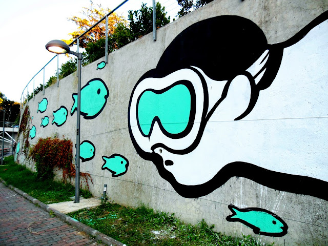 Italian Street Artist MP5 Paints a new mural entitled "Playing Upstream" in Terni, Italy. 1