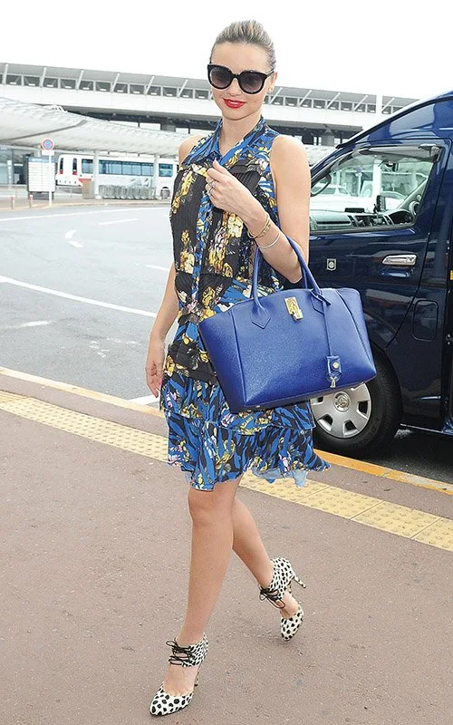 Miranda Kerr's airport fashion of an Alexander McQueen floral dress and leopard print heels