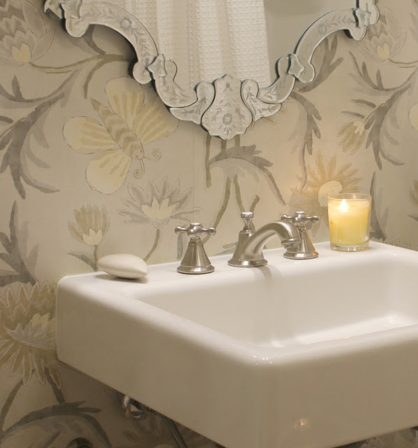 A gorgeous and classic widespread bathroom faucet (Seabury by GROHE) is paired with a DXV Oak Hill bathroom console sink in this timeless classic bath by Hello Lovely Studio.