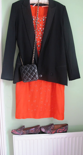 orange dress accessorised with black and paisley