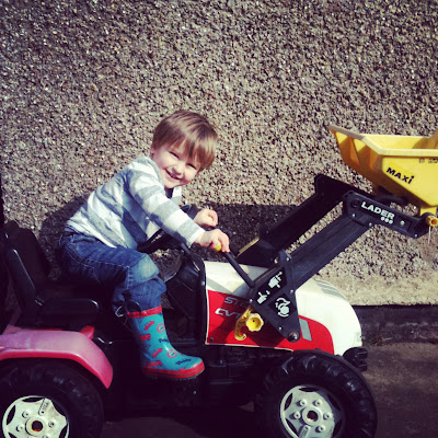 child on toy tractor