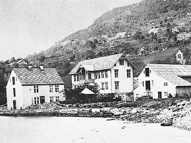 Hotel Ullensvang as seen in 1875 in this historical travel photo showing the original steamship agency to the left and the guest house in the center.