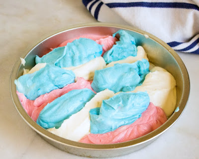 stripes of red, white and blue ice cream in pan ready to freeze