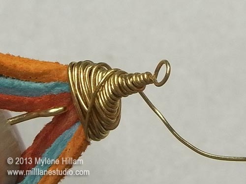 Finishing off the wire wrapping around the top of the suede tear drop