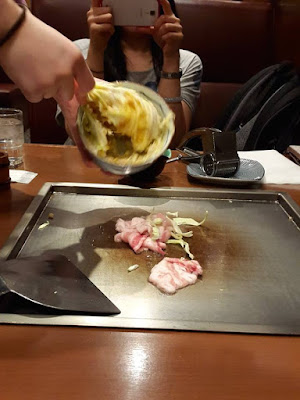 Cooking okonomiyaki in Shinjuku Tokyo Japan