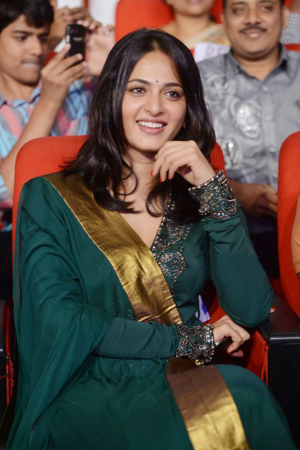 Glamorous Anushka Shetty Smiling Face Photos In Green Dress