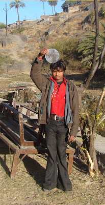 "Khemoo our handyman a teibal fron Rajasthan holding up a plate of ice formed in the dogs drinking water bowl."