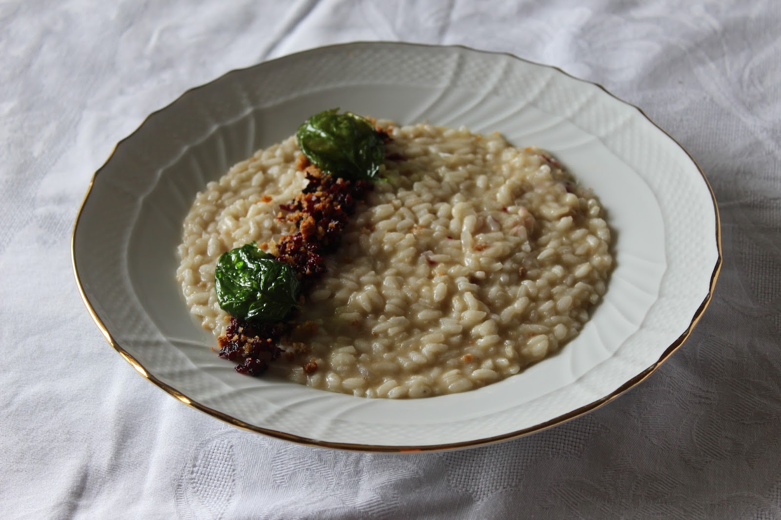 risotto alle alici con briciole di rapa rossa e basilico fritto.