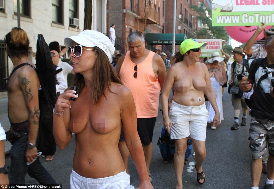 Hundreds of women went bare breasted in Manhattan on Sunday to mark "G...