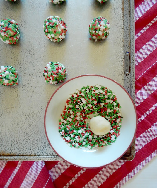 Soft Batch Christmas Sprinkle Cookies....a soft, tender, almond flavored sugar cookie coated in holiday sprinkles!  A kid favorite! Perfect for Santa and all your holiday gatherings. (sweetandsavoryfood.com)
